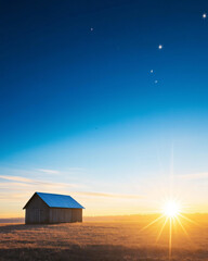 Rustic wooden house barn in an open field at sunrise under a clear blue sky. Concept of simplicity and calm.
