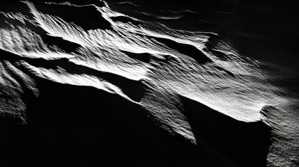 Obraz premium Close-up of small dunes and ridges on dry beach sand, highlighted by sharp sunlight and shadows