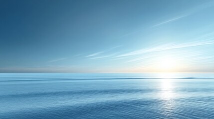 Fototapeta premium Serene Ocean Landscape: Clear Blue Sky, Bright Sun, Calm Waters, and Gentle Waves on a Peaceful Horizon