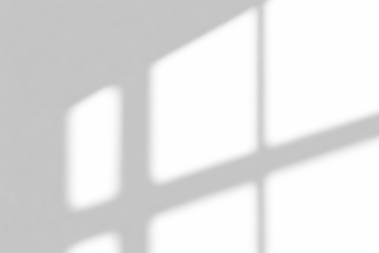 A bright abstract composition of intertwined shadows and light on a surface, forming an intimate visual texture.