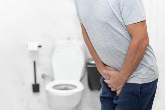 Person with urinary problems, Medical problem urinary incontinence. people with crotch pain, Man with hands on crotch with urinary problems	
