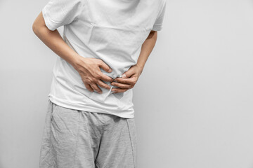 Men have stomachache and use their hands to hold their stomach In the bathroom. Constipation or...