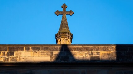 Cross and Spire Against Clear Blue Sky in Serene Landscape