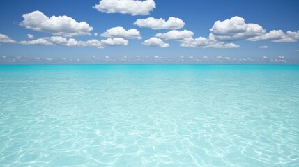 Obraz premium Serene turquoise ocean under a clear blue sky.