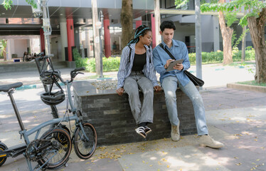 Obraz premium Commuting to work with bicycle. Young business person cycling and riding electric scooter to office in downtown district. Modern diversity people use eco transportation in city. Sustainable lifestyle.