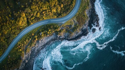 Aerial view of winding highway along the coast, cliffs and ocean waves, pastel dawn light
