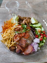 Khao Kluk Kapi, a popular dish in Thailand or Shrimp Paste Fried Rice Including of rice mixed with fragrant shrimp paste, Chinese sausage, sweet pork, shredded egg, dried shrimp, lime, yard long beans