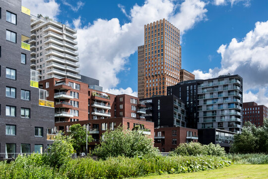 striking view of modern urban architecture displaying a variety of residential buildings with unique designs, showcasing contemporary urban living and eco-friendly structures in Amsterdam Netherlands