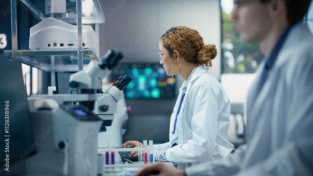 Leinwandbilder Portrait of a Beautiful Latin Student Working on a Research Project in College. Medical Research Scientist Looking at Biological Samples on a Computer in an Applied Science Laboratory
