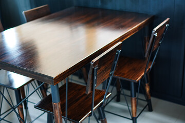 Side view of a set of wood and steel frame dining chairs in a coffee shop, Chiang Mai, Thailand.