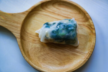 Photo of homemade food menu: Steamed Wide Rice Noodles with Tofu and Amaranth on a wooden food plate.