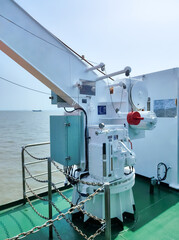 Detailed View of Marine Equipment on a Ship Deck Under Clear Skies