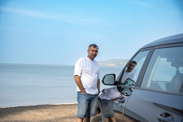 Man working with laptop on beach.