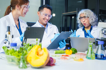 A male scientist and two women conduct plant research in a laboratory.  microscopes, petri dishes,test tubes to analyze genetically modified plants, food, meat, eggs,vegetables for nutritional value