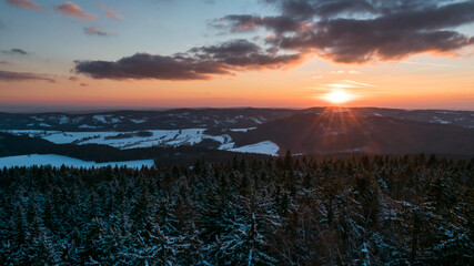 Colorful sunset over the Czech countryside. View from the Teplice-Adršpašské rocks of the Giant Mountains and the surrounding hills.