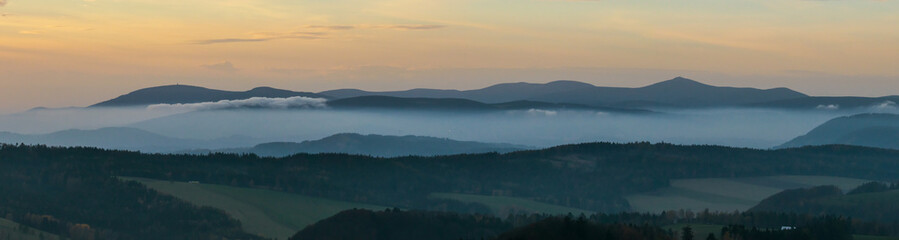 Colorful sunset over the Czech countryside. View from the Teplice-Adršpašské rocks of the Giant Mountains and the surrounding hills.
