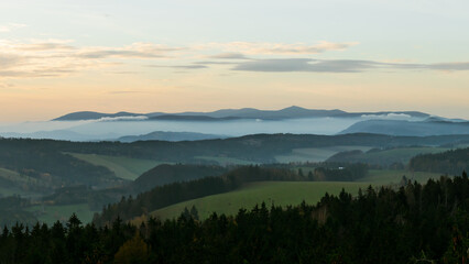 Colorful sunset over the Czech countryside. View from the Teplice-Adršpašské rocks of the Giant Mountains and the surrounding hills.