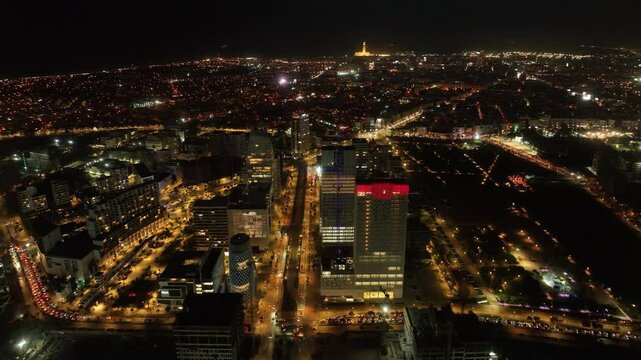 Nighttime aerial view of Casablanca with the illuminated Hassan II Mosque and CFC. This 4K footage highlights vibrant lights, modern architecture, and Morocco&rsquo;s cultural landmarks