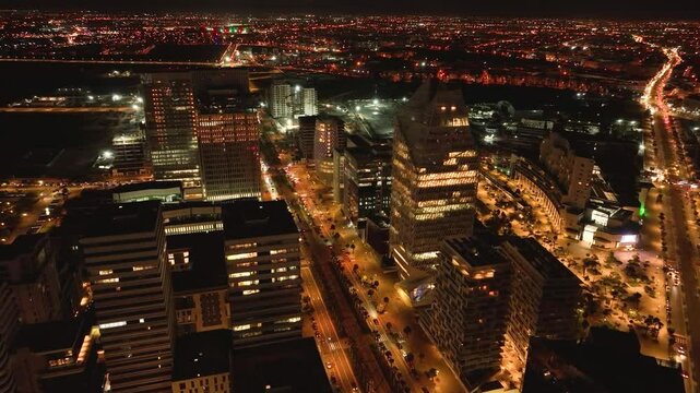 This 4K nighttime drone footage starts at CFC buildings and reveals a busy street filled with vibrant car lights. Perfect for cityscape and urban nightlife projects.