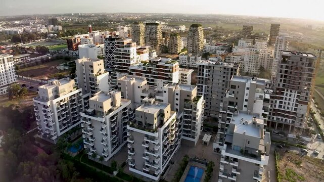Daytime drone view of CFC with sunlit buildings, lush greenery, and ongoing construction. This 4K footage captures Morocco&rsquo;s urban growth and sustainable development.