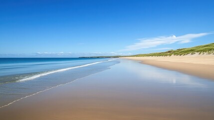 A pristine empty beach with turquoise blue waters, soft golden sands, and a clear blue sky. Perfect for summer banners.