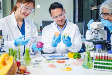 A male scientist and two women conduct plant research in a laboratory.  microscopes, petri dishes,test tubes to analyze genetically modified plants, food, meat, eggs,vegetables for nutritional value