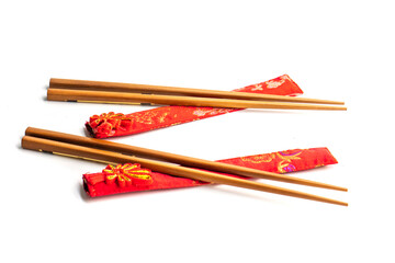 wooden chopsticks and red cloth case on white background