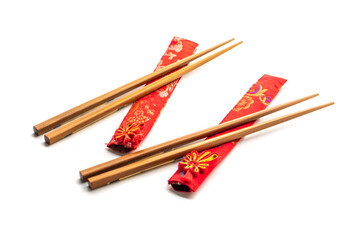 wooden chopsticks and red cloth case on white background