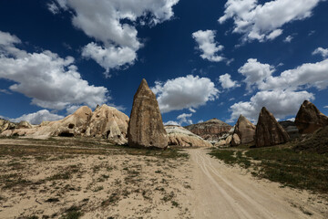 Fototapeta premium Cappadocia is a semi-desert region in central Turkey. It is famous for its fairy chimneys - tall cone-shaped rock formations, which are especially numerous in Pasabag Monks Valley and Goreme Valley.