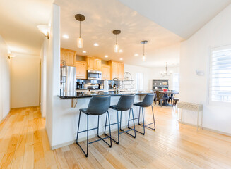 Modern kitchen with bar seating set in a bright, airy space designed for family gatherings and culinary activities
