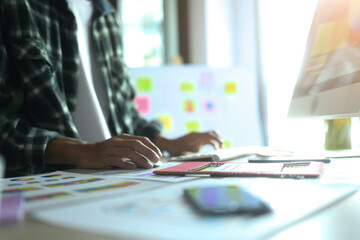 Close up of young designer working on wireframes for a mobile application at office