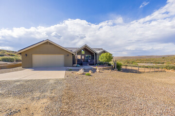 Modern house with expansive views in a quiet desert setting during a sunny afternoon