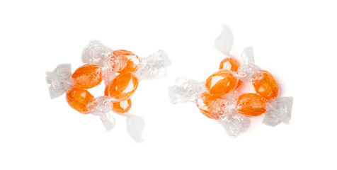 Orange hard candies isolated. Scattered lollipop pile, wrappers fruit confectionery group, round...