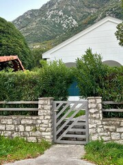 Charming stone gate leading to a lush garden in the mountains