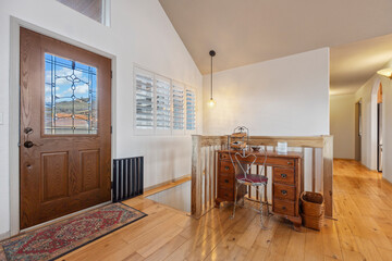 Elegant entryway with wooden floors and charming decor enhances the welcoming atmosphere of a cozy home in a serene setting