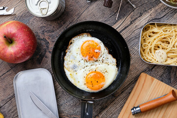 Fried Eggs at Camp on Wooden Table