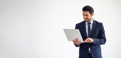 Male standing with laptop computer isolate on white background. Portrait of Confident successful business people woking in office. rich confident business man owner in office.