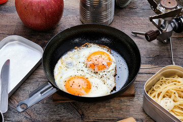 Fried Eggs at Camp on Wooden Table
