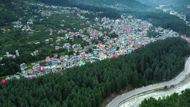 Aerial view of manali with the beas river in himachal pradesh India. Himalayan mountains and colourful local houses nestled in the hills of manali himachal pradesh India.