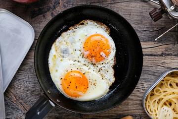 Fried Eggs at Camp on Wooden Table
