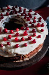 Delicious ready to eat wreath Christmas cake decorated with fresh cranberries and cream cheese frosting with festive styling