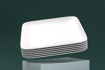 A stack of white plates is shown in a photo