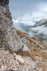 Vertical shot of the Mount Fisht covered with thick fog and clouds in autumn, Adygea, Russian Federation