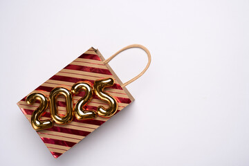 Happy New Year 2025 shopping. Shopping bag with 2025 numbers. Advertising, promotion, sale
