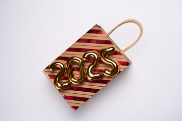 Happy New Year 2025 shopping. Shopping bag with 2025 numbers. Advertising, promotion, sale