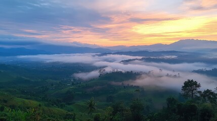 Foggy rural sunrise over mountains with dispersed clouds creating a serene landscape in a misty morning atmosphere.