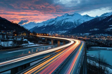 A highway with a bridge over a river and mountains in the background