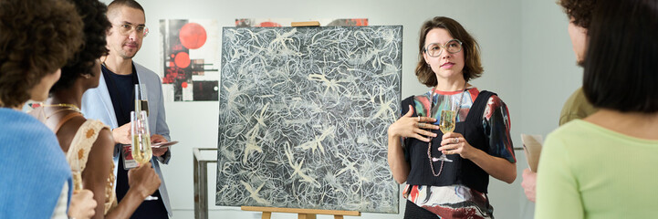 Banner of young owner of art gallery holding glass of champagne and communicating to visitors of exhibition opening event