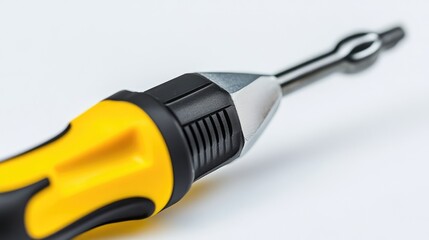 Close-up view of a yellow and black screwdriver on a white background showcasing its design and functionality for tool-related concepts.