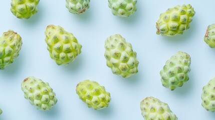 Noni fruits arranged on a light background showcasing their unique texture and natural green color for health and wellness themes.